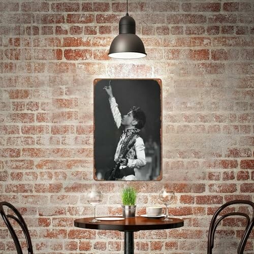 Cafe interior with brick wall and framed black-and-white photo.