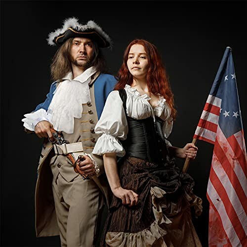 Couple in colonial costumes holding a historical flag.