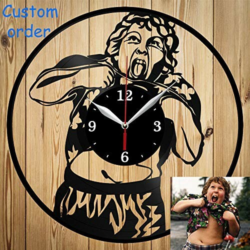 Custom wall clock featuring a cutout design of a child playfully sticking out their tongue, set against a wooden background.