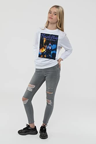 Teen girl in a white graphic sweatshirt and ripped gray jeans