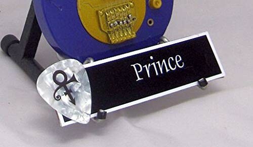 Guitar pick and nameplate with 'Prince' inscription