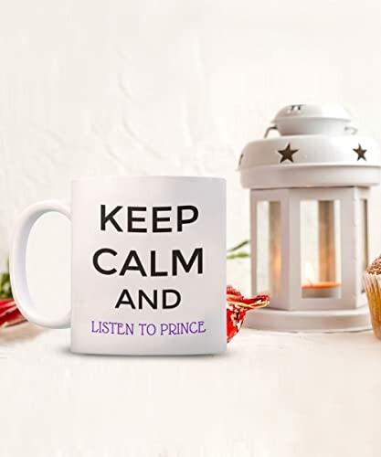 Mug with 'Keep Calm and Listen to Prince' text next to a lantern