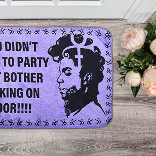 Purple door mat with silhouette and decorative design.