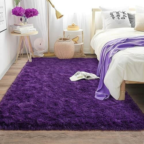 Cozy bedroom with a purple fluffy rug beside a bed.