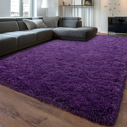 Purple fluffy rug in a modern living room with a grey sectional sofa and hardwood floors.