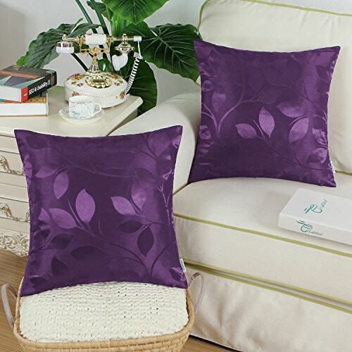 Purple leaf pattern cushions on a white sofa.