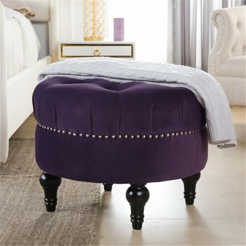 Purple ottoman with blanket in bedroom