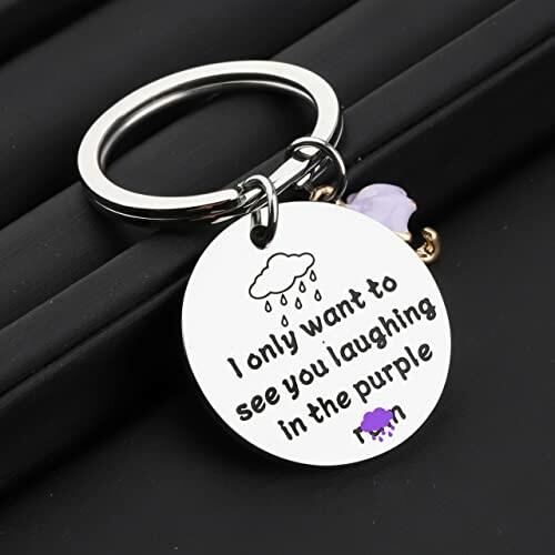 Keychain with quote about laughter and purple.