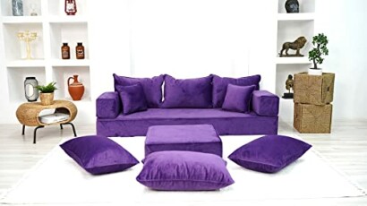 Modern living room with a purple sofa set and cushions.