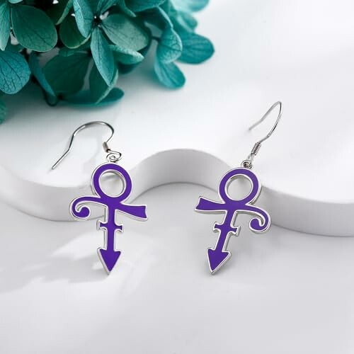 Purple symbol earrings with plant background