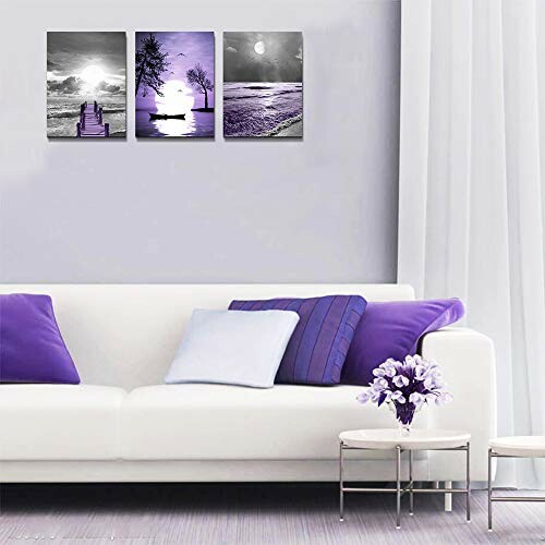 Living room with white sofa, purple cushions, and purple-toned wall art.