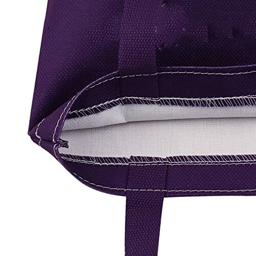 Bottom view of a purple tote bag with visible stitching.