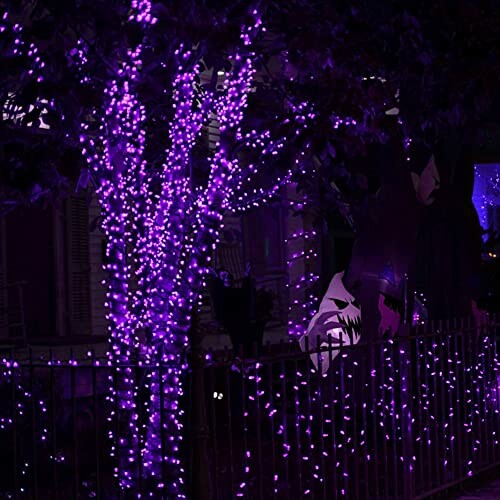 Tree wrapped in purple lights at night