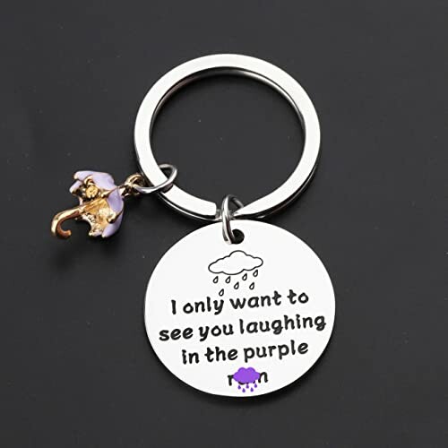 Keychain with umbrella charm and text about laughing in the purple.