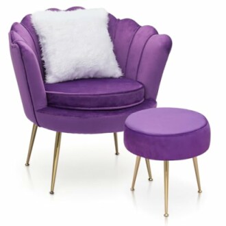 Purple velvet chair with a fluffy white pillow and matching ottoman.