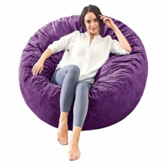 Woman sitting on a large purple bean bag chair.